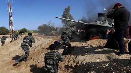 Palestinian actors dressed as militants attack a replica of Israeli tank