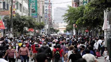 People walk in a crowded street as new cases of the coronavirus disease (COVID-19)