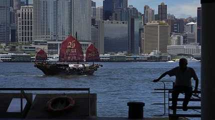 Chinese junk sails across Victoria Harbor to celebrate the 25th anniversary