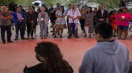 People gather for a vigil to mourn