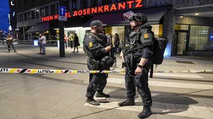 Police stand guard outside a bar in central Oslo