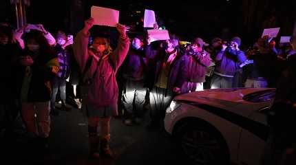 Protesters hold up blank papers and chant slogans