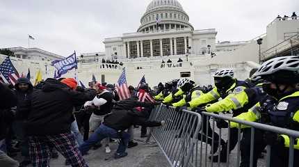 Insurrectionists loyal to President Donald Trump try to break through a police barrier