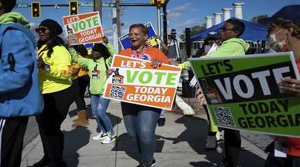 People gather during a get out the vote rally