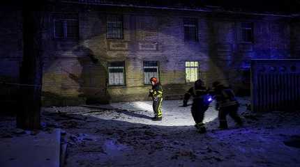 Rescuers work at the site of a building