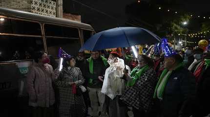 Residents carry a statue of baby