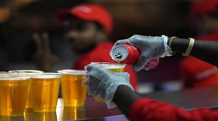 Staff member pours a beer