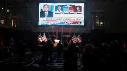 Supporters watch results