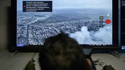 Ukrainian soldier watches a drone