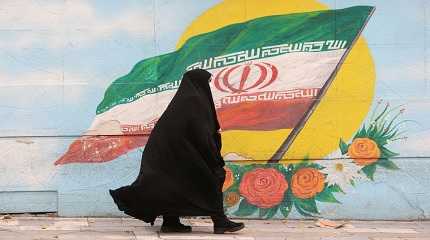 woman walks in a street in Tehran