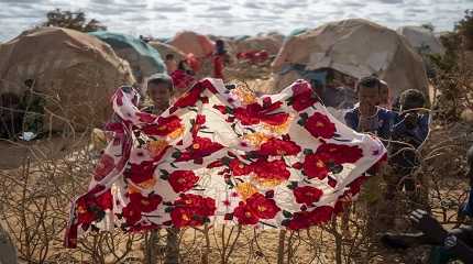 Children stand near shelters