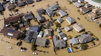 Floodwaters surround homes and vehicles in Monterey