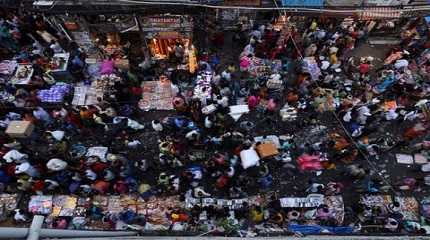 People shop at a crowded market