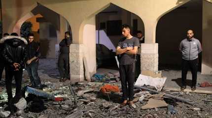 Palestinians inspect a damaged building