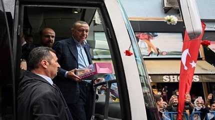 Tayyip Erdogan holds a present for supporters