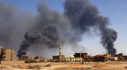 smoke rises above buildings