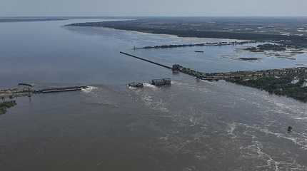 Water flows over the collapsed Kakhovka Dam