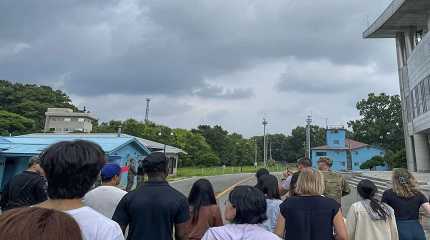 tourists stand near a border