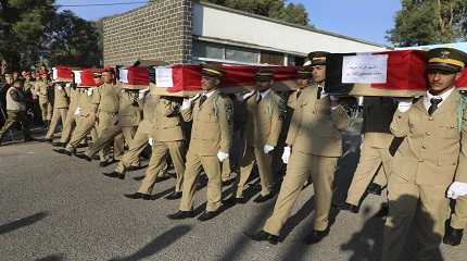 officers carry the coffins