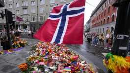 Norwegian national flag flutters over flowers and rainbow flags