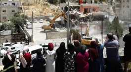Palestinians watching demolition of their homes