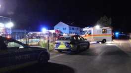 police and emergency services stand at an asylum seeker shelter after a knife attack