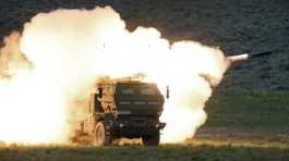 launch truck fires the High Mobility Artillery Rocket System (HIMARS