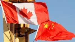 The flags of Canada and China in Beijing