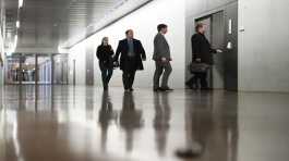 German lawmakers and officials enter a secure room