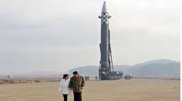 Kim Jong Un with his daughter walks away from an intercontinental ballistic missile