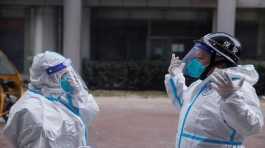Pandemic prevention workers in protective suits