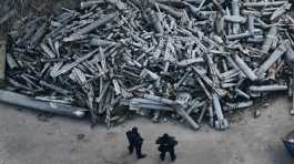 Police officers look at collected fragments of the Russian rockets