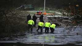 Police search teams at the scene after children fell through ice