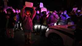 Protesters hold up blank papers