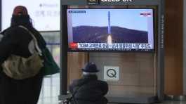 TV screen shows a image of North Koreas rocket