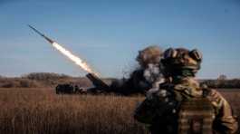 Ukrainian servicemen fire a multiple launch rocket