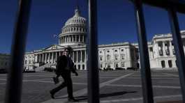 man walks past the U.S. Capitol building