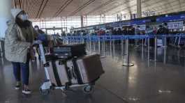 masked traveller arrives at the international flight