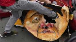 protester kicks an effigy of Philippine President Ferdinand Marcos