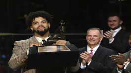 quarterback Caleb Williams holds the Heisman Trophy