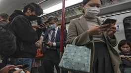 Commuters wearing face masks