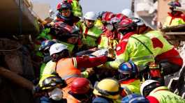 Rescuers carry a woman named Zeynep