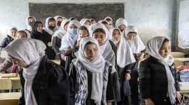 Girls stand in their classroom in Kabul