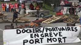 Striking dockers occupy a road 