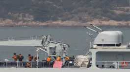 Soldiers stand on the deck of a Chinese warship