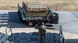 U.S. Air Force airman marshals a K-loader of cargo