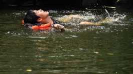 man swims in a canal