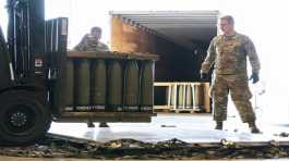 Airmen with the 436th Aerial Port Squadron place 155 mm shells