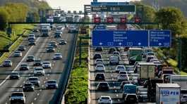 Cars and trucks queue on a highway after an accident