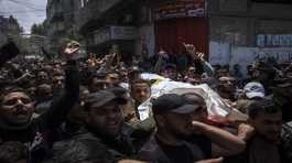 Mourners carry the bodies of Palestinians